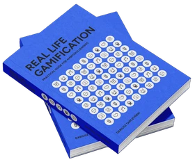 Stacked copies of the Real Life Gamification book by Dariusz Tarczyński